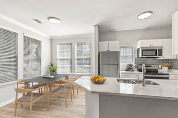 A modern kitchen with a dining table and chairs